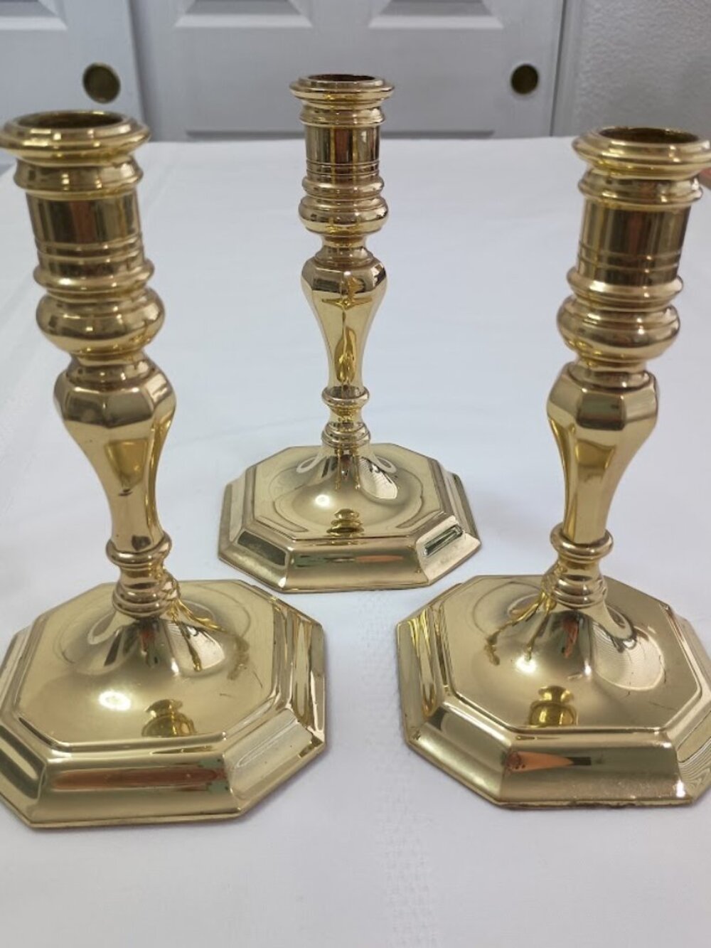 Set of Three Baldwin Polished Brass Candlesticks